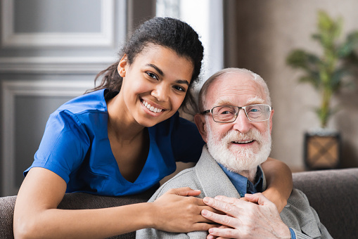 A Woman Hugging an Elderly Man