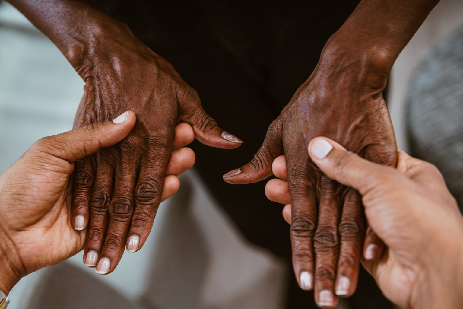 A Younger Hand Holding an Old Hand