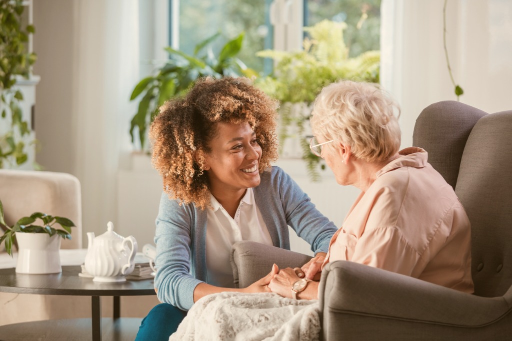 A Helper Smiling at an Elder Woman